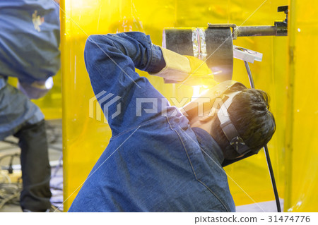 The welding craftsman welding the steel tube The welding craftsman welding the steel tube 31474776