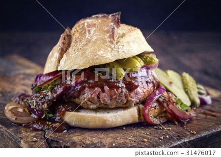 Hamburger with Chili Relish on old Cutting Board Hamburger with Chili Relish on old Cutting Board 31476017