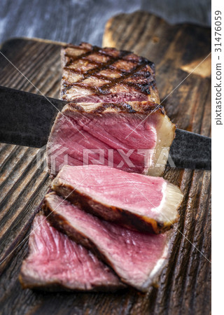 Barbecue New York Strip Steak on old Wooden Board 31476059