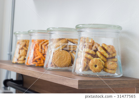 salty crackers in glass bottle on wooden shelf 31477565
