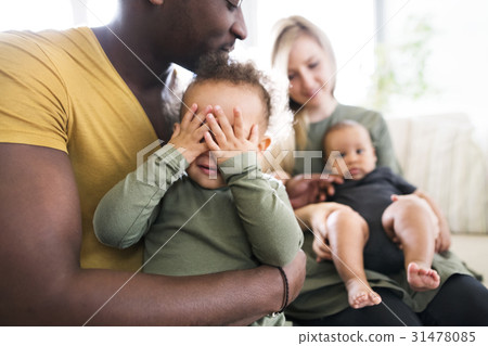 Young interracial family with little children at 31478085