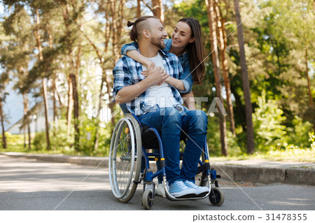 Smiling disabled man looking at his girlfriend Smiling disabled man looking at his girlfriend 31478355