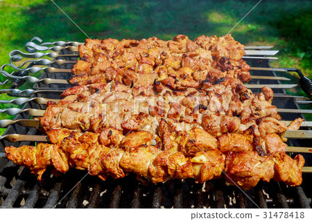 Pork on skewers cooked on barbecue grill. Pork on skewers cooked on barbecue grill. 31478418