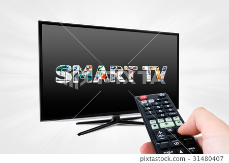 Hand with remote control aiming modern Smart TV 31480407