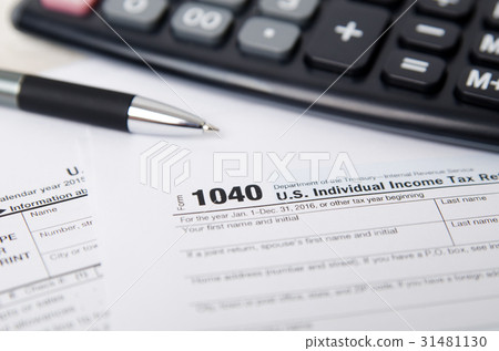 US tax form 1040 with pen and calculator 31481130