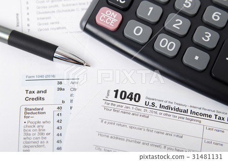 US tax form 1040 with pen and calculator 31481131
