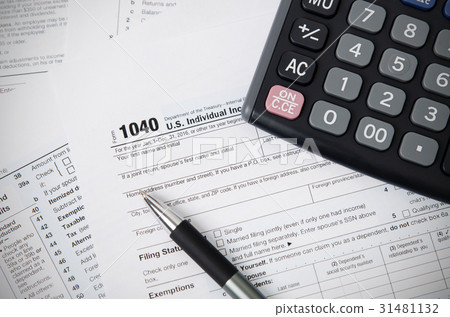 US tax form 1040 with pen and calculator 31481132