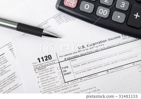US tax form 1120 with pen and calculator US tax form 1120 with pen and calculator 31481133