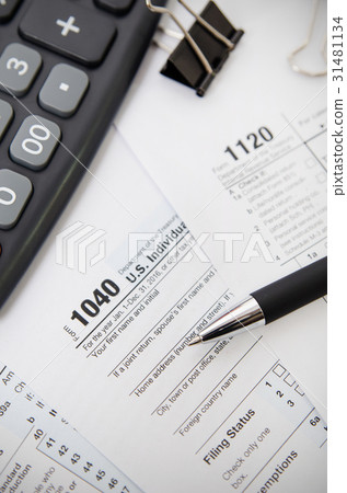 US tax form 1040 with pen and calculator 31481134