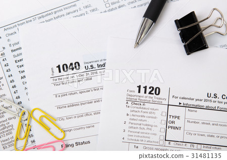 US tax form 1040, 1120 on desk US tax form 1040, 1120 on desk 31481135