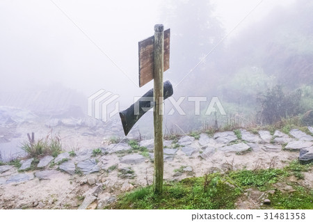 direction sign on mountain path in misty day 31481358