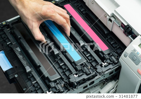 Man puts toner in the printer 31481877
