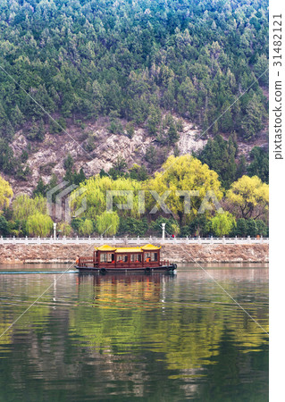 view of boat in Yi river and green East Hill 31482121