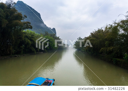 chinese boat on river near peaks near Xingping 31482226
