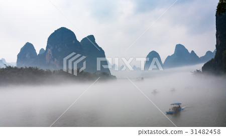 view of fog with boats on river near Xingping town 31482458