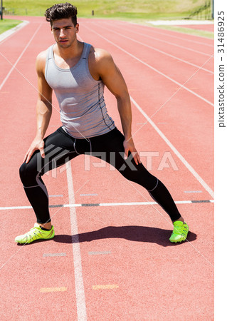 Athlete warming up on the running track Athlete warming up on the running track 31486925