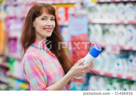 Beautiful woman posing with detergent Beautiful woman posing with detergent 31486956