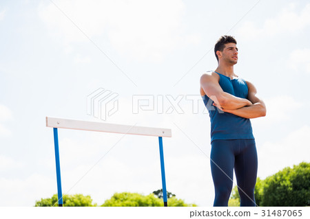 Athlete standing with arms crossed Athlete standing with arms crossed 31487065