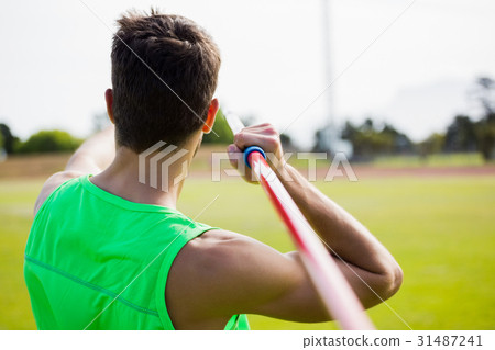 Rear view of an athlete about to throw a javelin 31487241