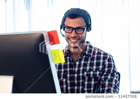 Portrait of smiling man wearing headset Portrait of smiling man wearing headset 31487308