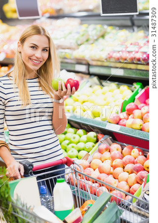 Customer at supermarket front of fruits shelf Customer at supermarket front of fruits shelf 31487309