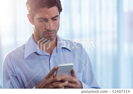 Businessman using a smartphone Businessman using a smartphone 31487314