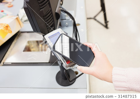 Close up of payment by mobile phone Close up of payment by mobile phone 31487315