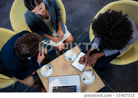 Businessmen interacting on a low table Businessmen interacting on a low table 31487318
