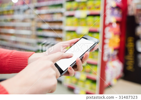 Focus on foreground of woman touching her mobile phone 31487323