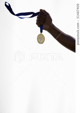 Hand of athlete holding gold medal Hand of athlete holding gold medal 31487409