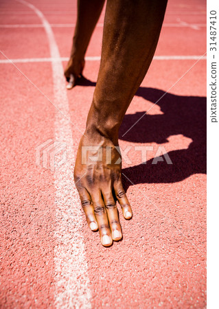 Hands of athlete on a starting line Hands of athlete on a starting line 31487410