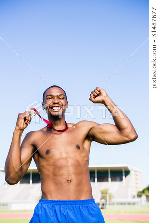 Athlete cheering with gold medal Athlete cheering with gold medal 31487677