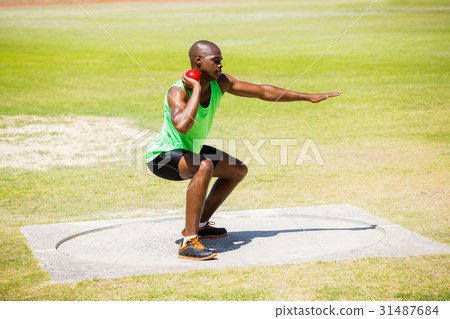 Male athlete preparing to throw shot put ball 31487684