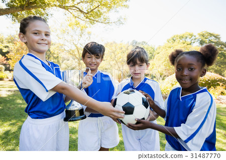 Winner kids posing together during a sunny day at camera 31487770