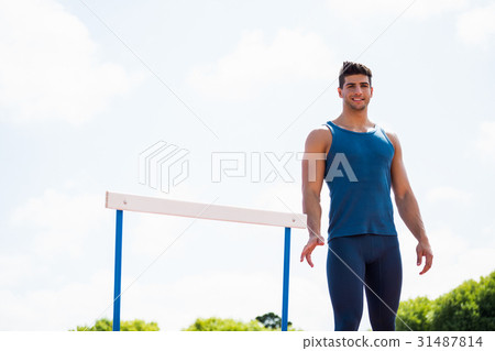 Athlete standing beside the huddle Athlete standing beside the huddle 31487814