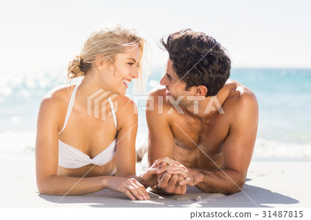 Young couple lying on beach Young couple lying on beach 31487815