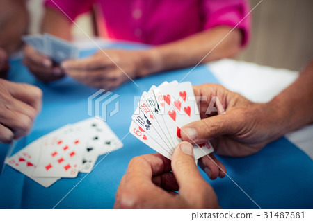 Group of seniors playing cards 31487881