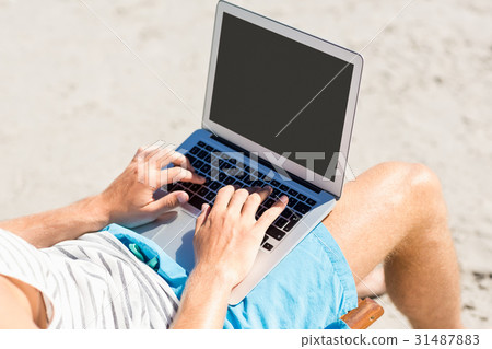 Man sitting on armchair at beach 31487883