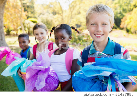 Kids posing with their gift surprise during a sunny day 31487993