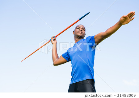 Athlete about to throw a javelin 31488009