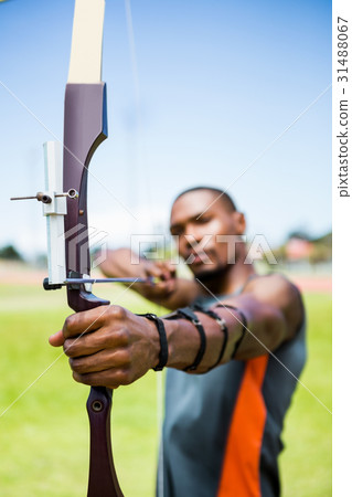 Athlete practicing archery Athlete practicing archery 31488067