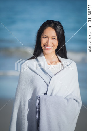 Young woman standing on beach Young woman standing on beach 31488765