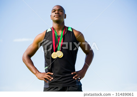 Athlete with gold medals around his neck Athlete with gold medals around his neck 31489061