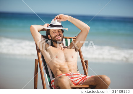 Young man relaxing on armchair 31489133