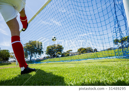 Football player scoring a goal 31489295