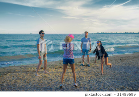 friends playing volleyball on a wild beach during friends playing volleyball on a wild beach during 31489699
