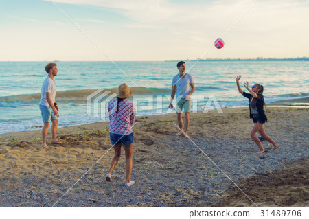 friends playing volleyball on a wild beach during friends playing volleyball on a wild beach during 31489706