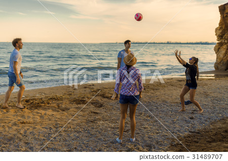 friends playing volleyball on a wild beach during friends playing volleyball on a wild beach during 31489707