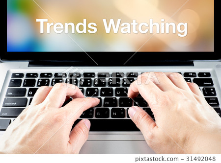 hand type on laptop with trends watching 31492048