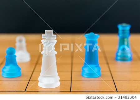 Chess glass on a wood chessboard 31492304